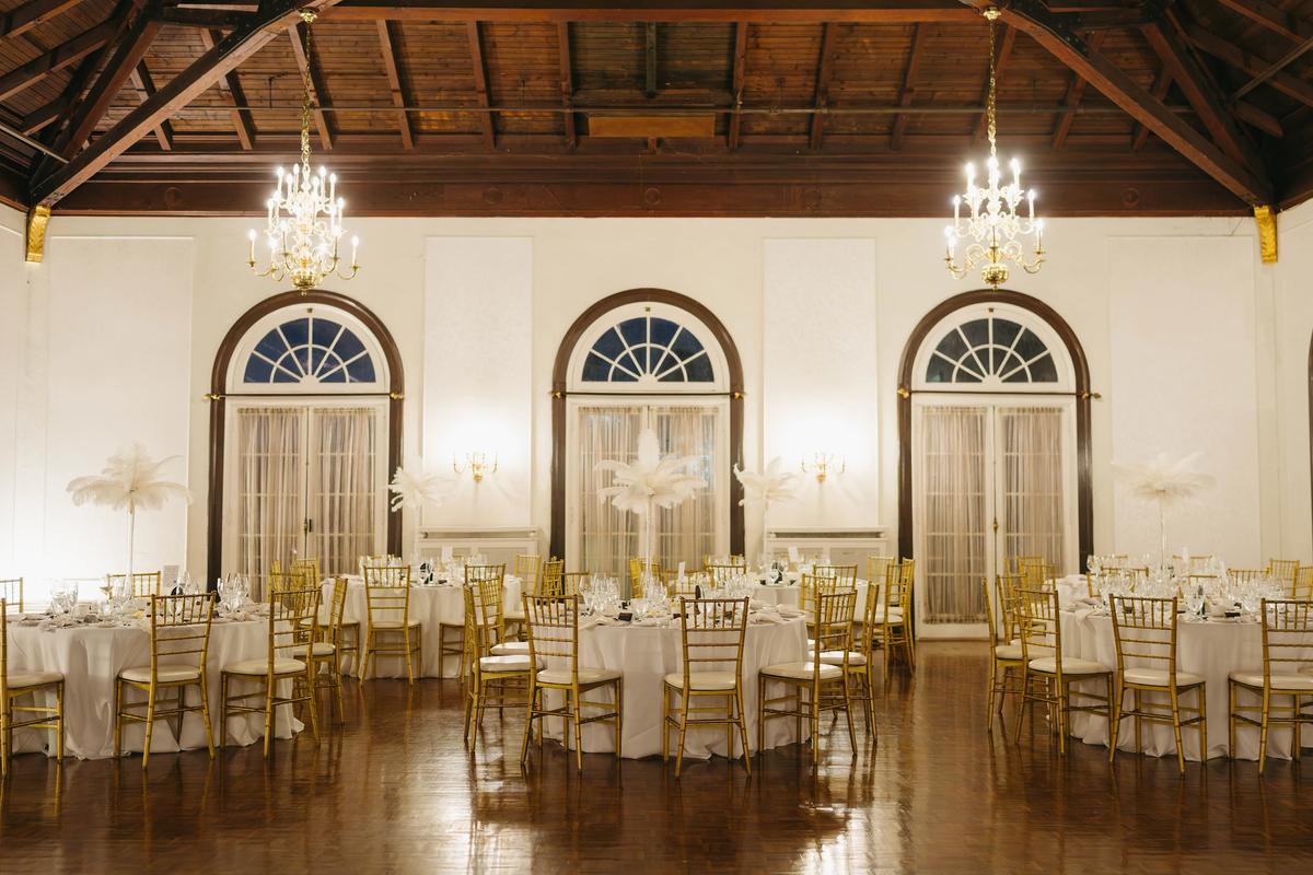 Bride and groom sharing a first dance at the Boulevard Club with guests looking on