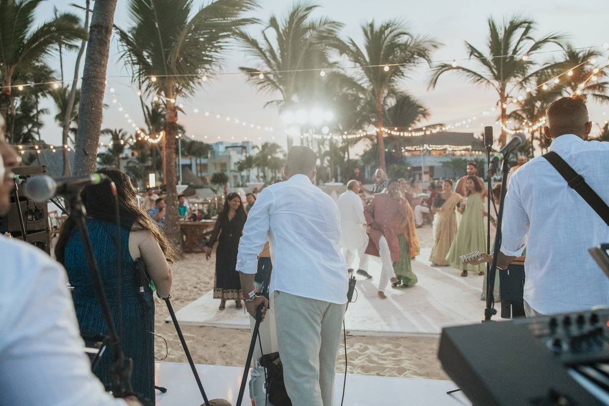 Musicians performing a daytime set at a scenic lakeside wedding ceremony in Ontario