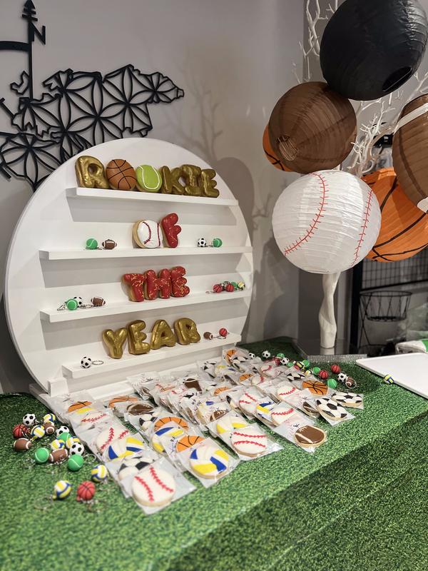 Beautifully coordinated first birthday celebration with custom decor and balloon display